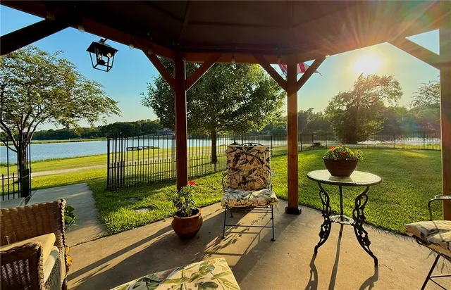 a view of swimming pool with a patio and a garden