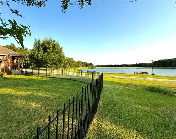 a view of a swimming pool with a garden and trees