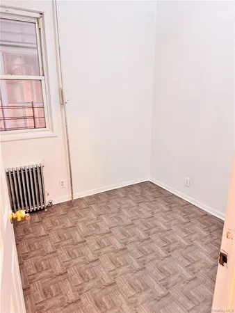 a view of a livingroom with wooden floor and a window