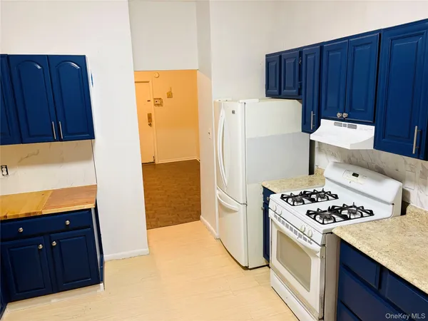 an empty room with cabinet and mirrors