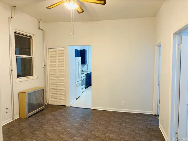 a view of a livingroom with an empty space and a stove top oven