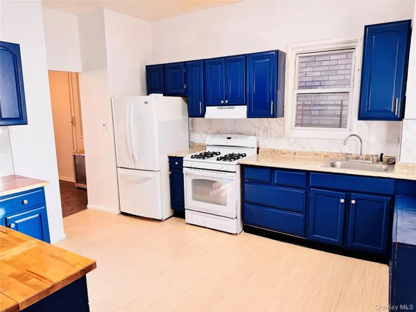 a kitchen with a stove a sink and a refrigerator