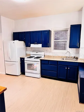 a kitchen with a cabinets and wooden floor
