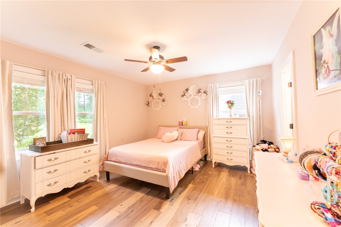 103 Riggs Drive Clemson, SC 29631 - Photo 27 of 50 Well-lit sleeping quarters with rich hardwood flooring and a functional ceiling fan.