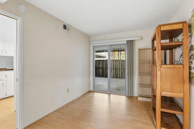 a view of an entryway with wooden floor and door