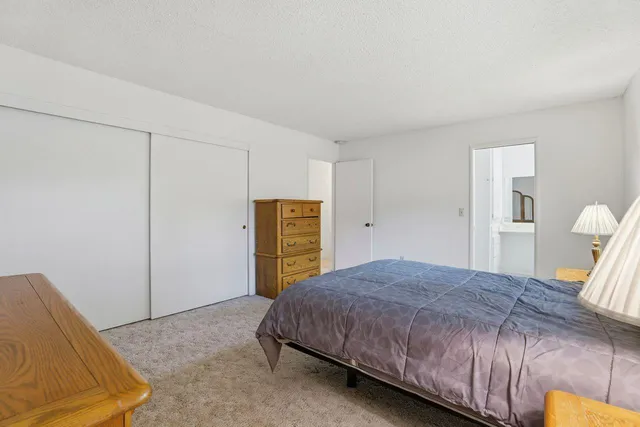 a bedroom with a bed and a table