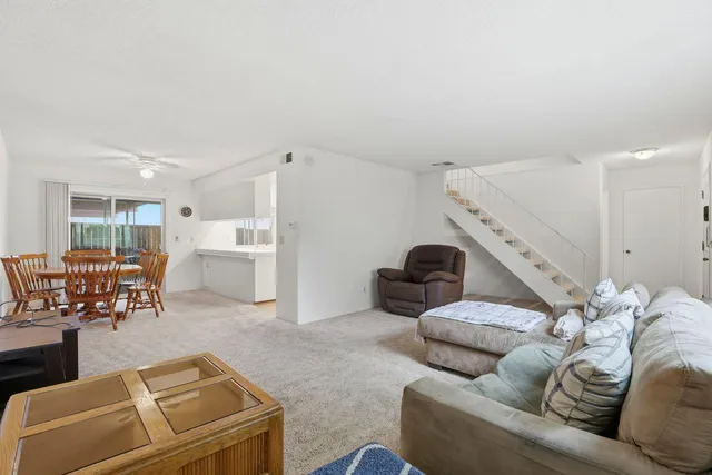 a living room with furniture and kitchen view