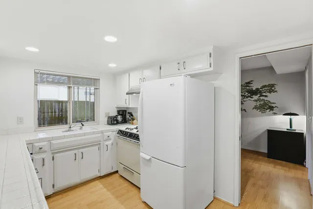 a white refrigerator freezer sitting inside of a kitchen