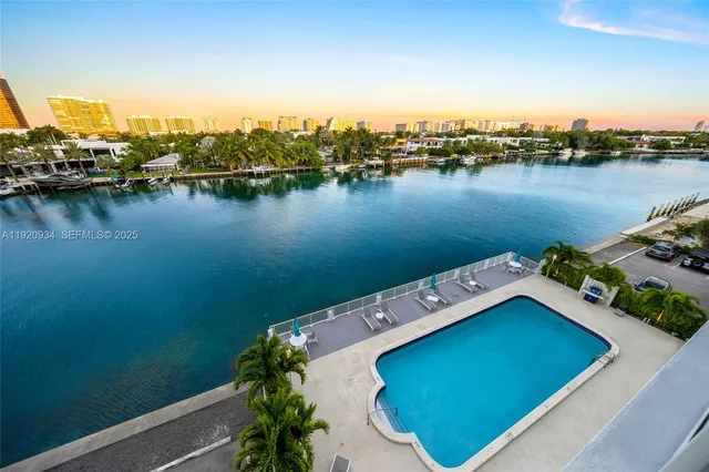 a dining room with furniture and a floor to ceiling window