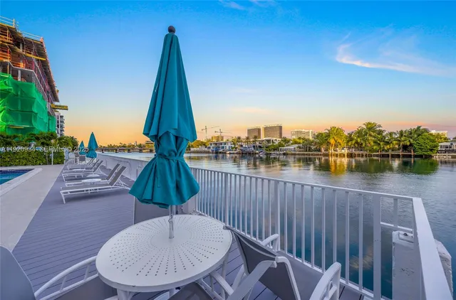an aerial view of a city with lots of residential buildings and ocean view in back