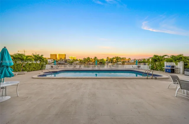 an aerial view of residential houses with outdoor space and swimming pool