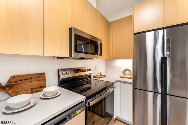 a kitchen with a refrigerator and a stove top oven