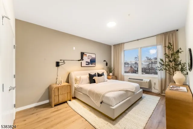 a bedroom with a large bed and a large window