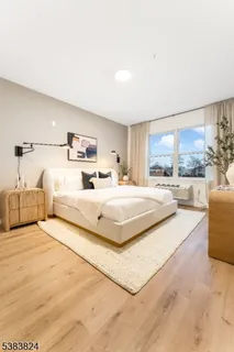 a bedroom with a large bed and a large window