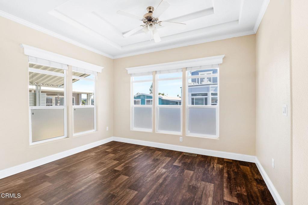 5540 West 5th Street, Unit 1 Oxnard, CA 93035 - Photo 12 of 35 an empty room with wooden floor and windows