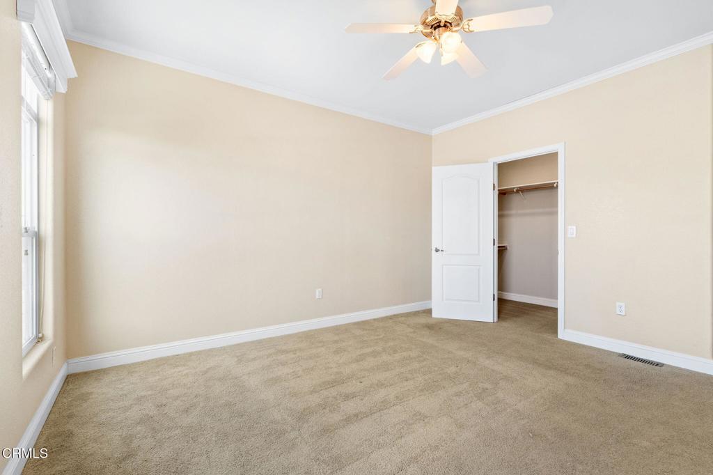 5540 West 5th Street, Unit 1 Oxnard, CA 93035 - Photo 18 of 35 an empty room with a ceiling fan and a window