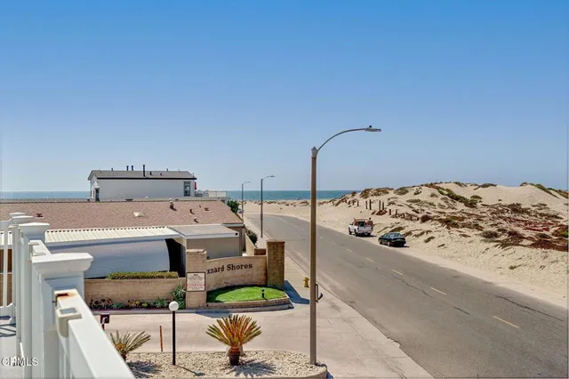a bed sitting in a bedroom next to a larger window