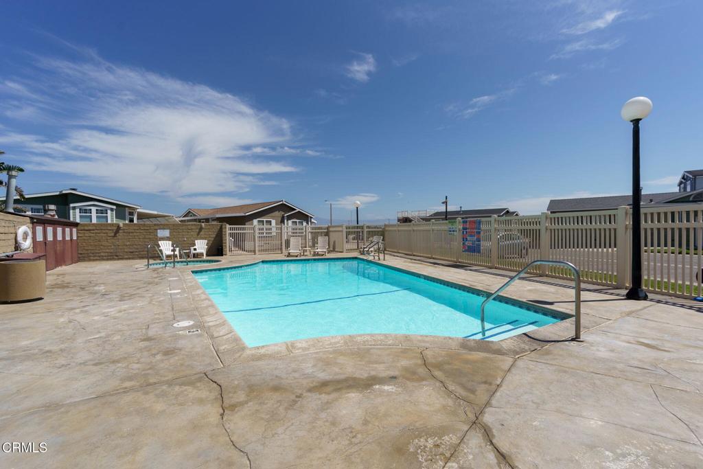 5540 West 5th Street, Unit 1 Oxnard, CA 93035 - Photo 30 of 35 a view of a swimming pool with a yard