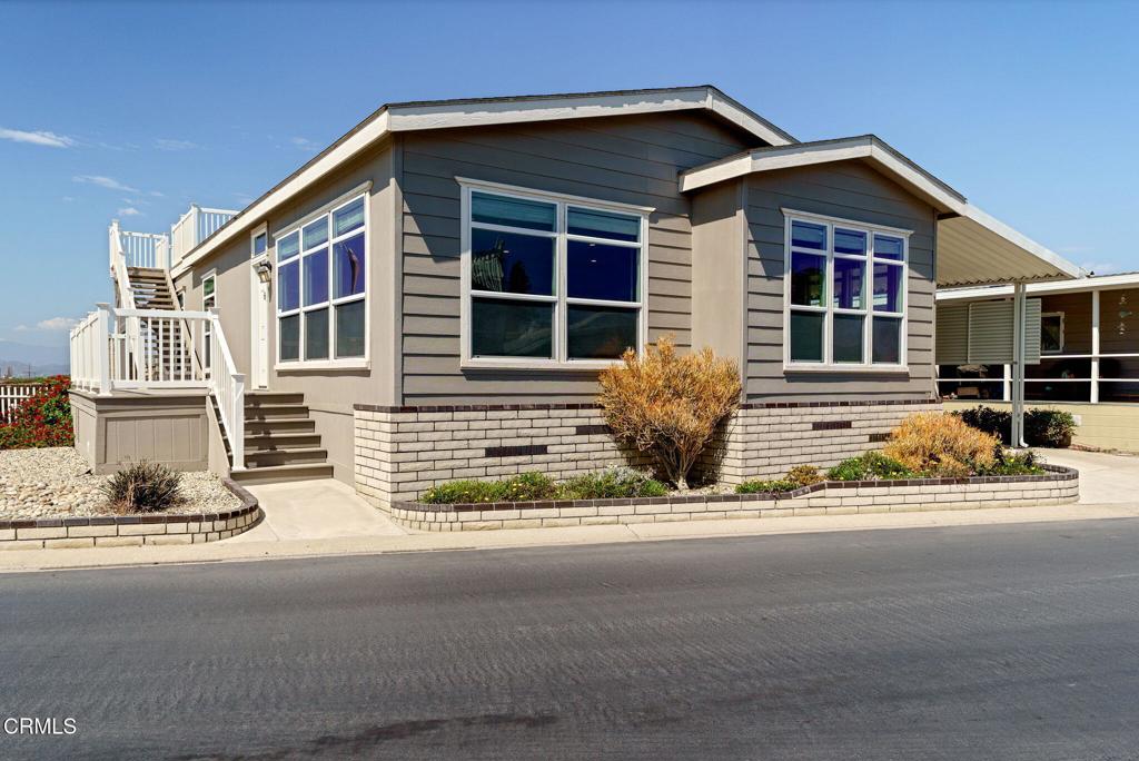 5540 West 5th Street, Unit 1 Oxnard, CA 93035 - Photo 4 of 35 a front view of a house with a yard