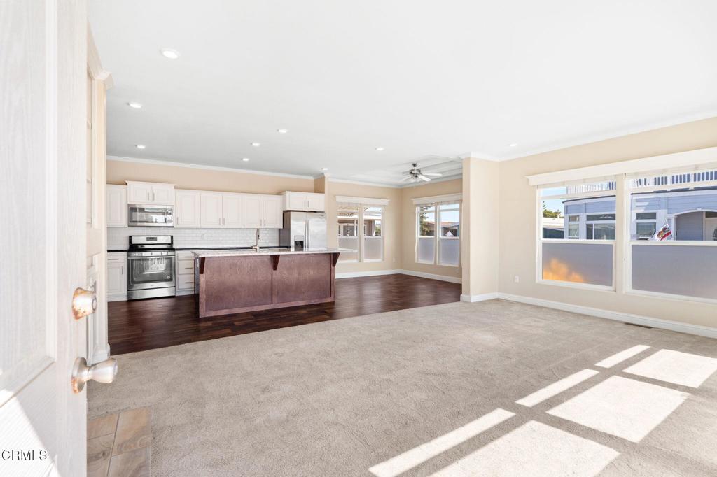 5540 West 5th Street, Unit 1 Oxnard, CA 93035 - Photo 7 of 35 a view of a kitchen with refrigerator and windows