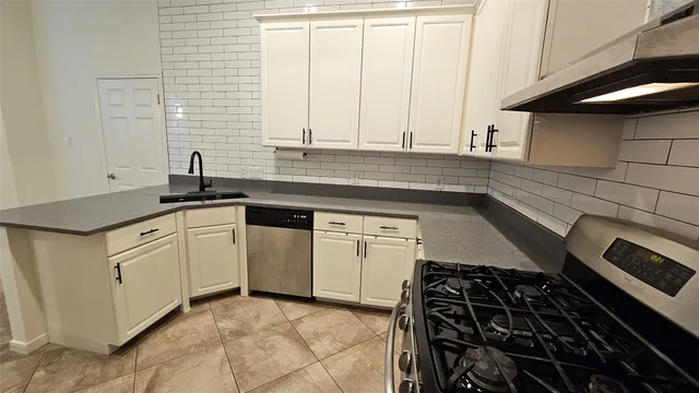 a kitchen with a sink and cabinets