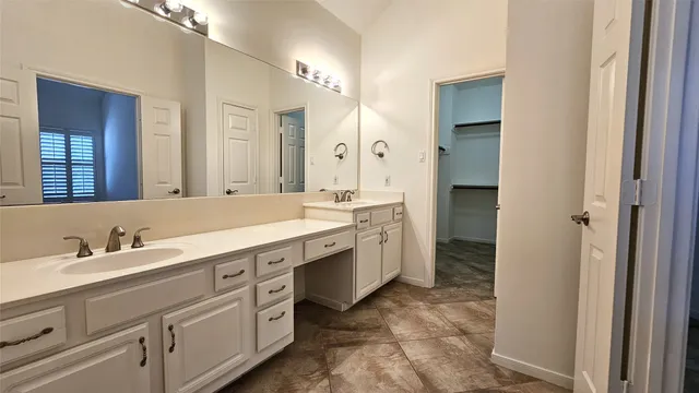 a spacious bathroom with a double vanity sink double and mirror