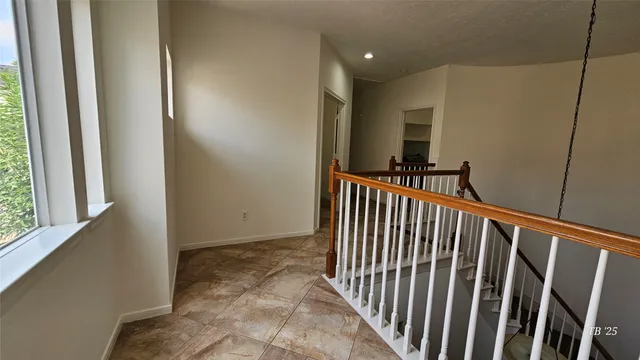a view of a hallway with windows