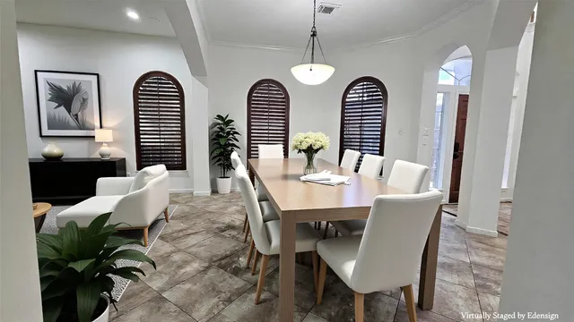 a view of a dining room with furniture and chandelier