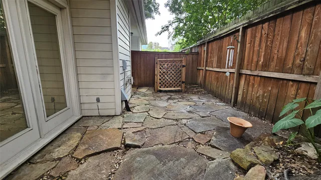 a front view of a house with a garage and a tree