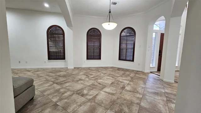 a view of an empty room with windows