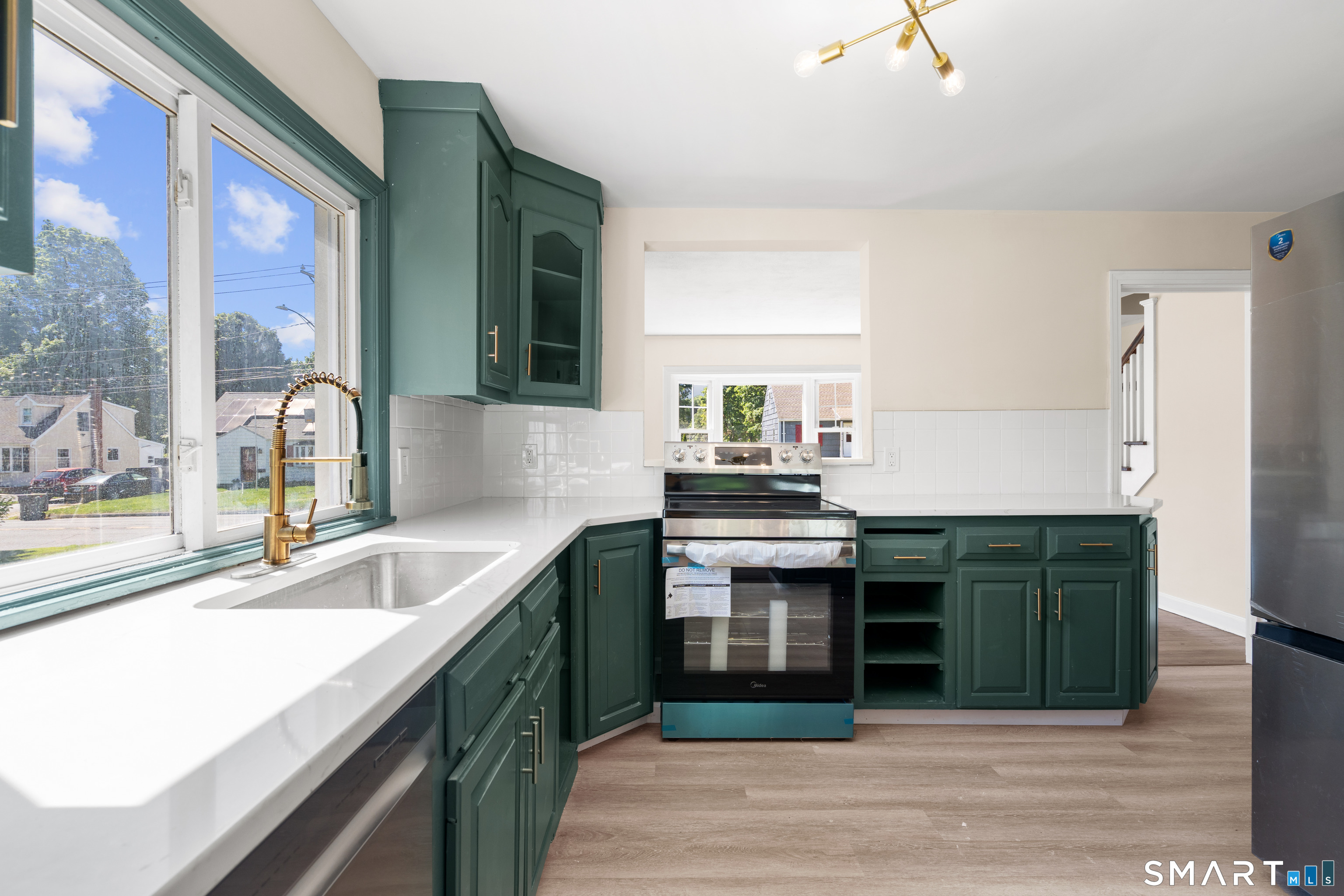 175 Moody Street Bristol, CT 06010 - Photo 11 of 28 a kitchen with a sink and a stove top oven