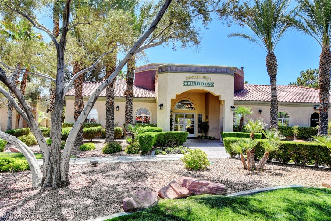 7885 West Flamingo Road, Unit 1050 Las Vegas, NV 89147 - Photo 37 of 62 A vibrant clubhouse, surrounded by mature palm trees and manicured landscaping, offers an inviting community hub.