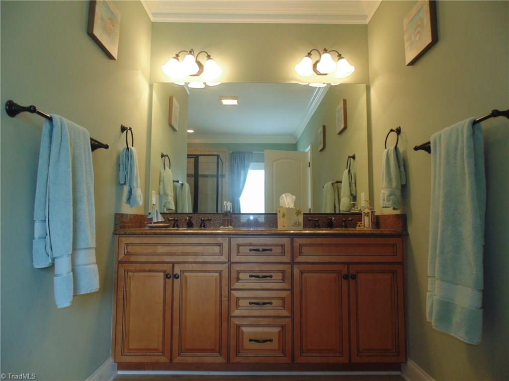 8192 Rylan Drive Browns Summit, NC 27214 - Photo 12 of 21 Two vanities, gorgeous cabinets, a stand alone tile shower, garden tub and access to the large walk-in closet are all part of the mast bath oasis.