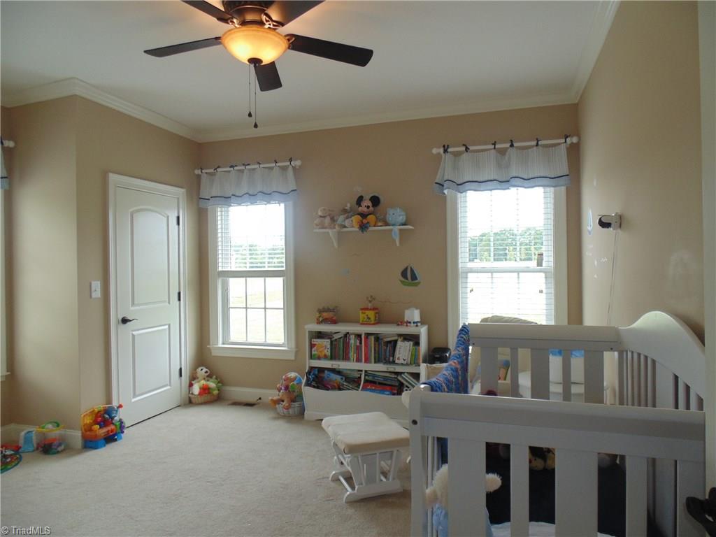 8192 Rylan Drive Browns Summit, NC 27214 - Photo 14 of 21 The second bedroom has double closets and three windows for natural light!