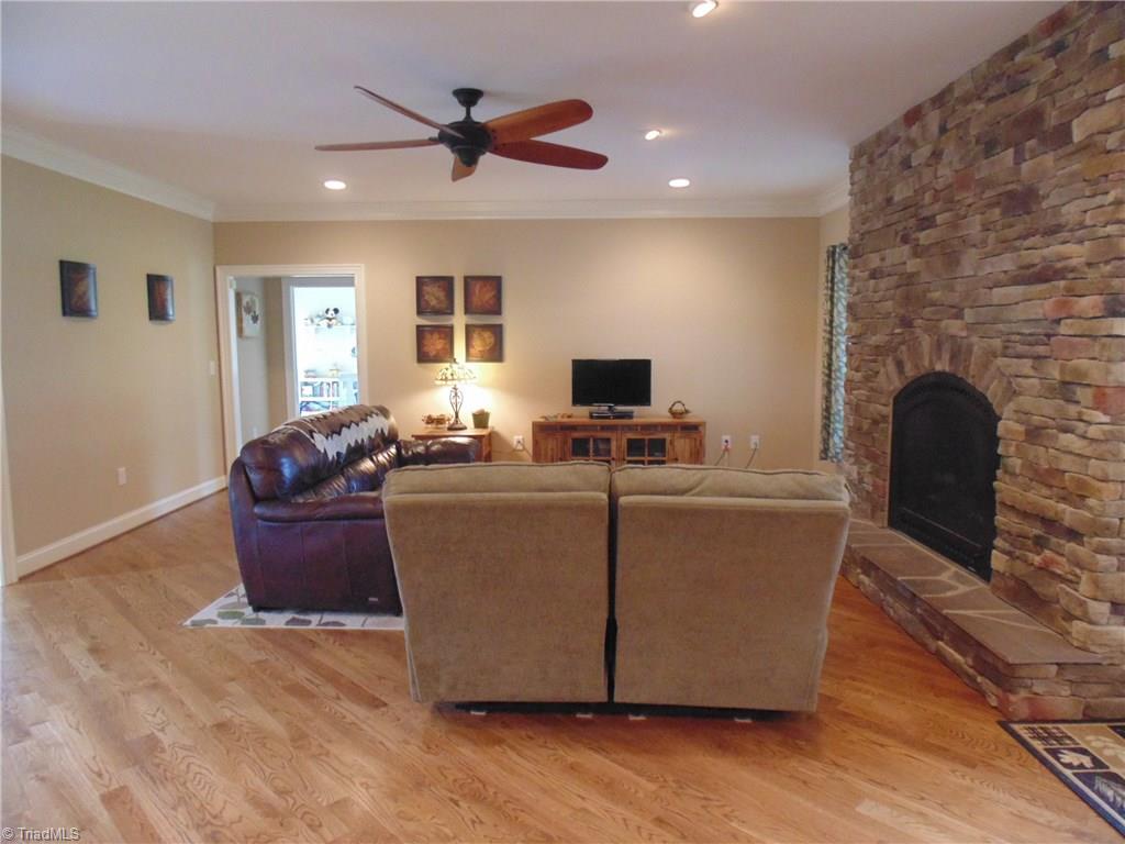 8192 Rylan Drive Browns Summit, NC 27214 - Photo 6 of 21 Note the incredible natural stone fireplace which creates a cabin feel and the diagonal hardwood floors that add dimension to the room!