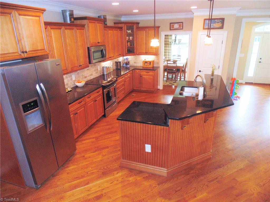8192 Rylan Drive Browns Summit, NC 27214 - Photo 9 of 21 This photo illustrates the ample space the beautiful kitchen has to offer!
