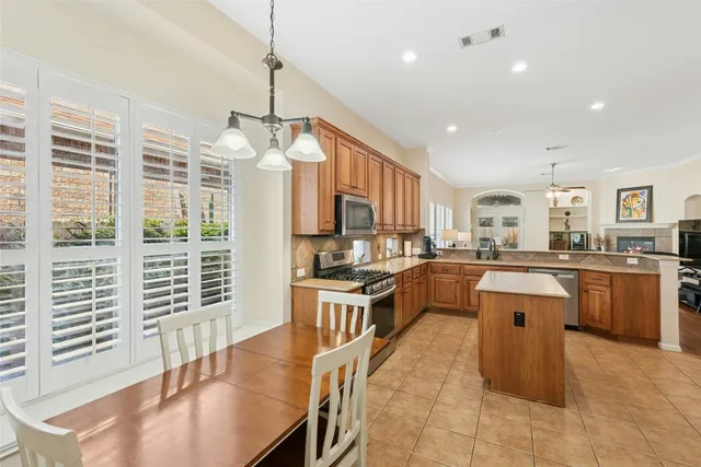 a kitchen with counter top space appliances and windows
