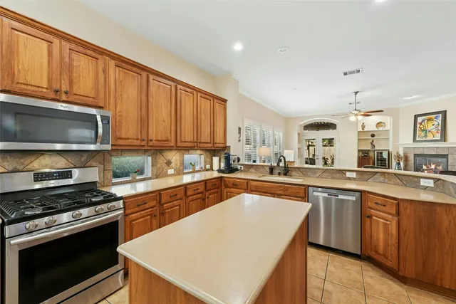 a kitchen with stainless steel appliances granite countertop a stove sink microwave and cabinets