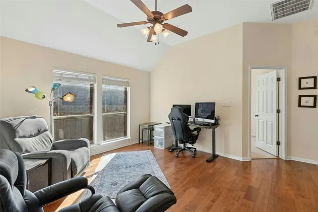 a living room with furniture and a wooden floor