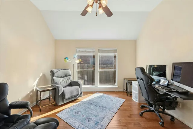 a living room with furniture a rug and a large window
