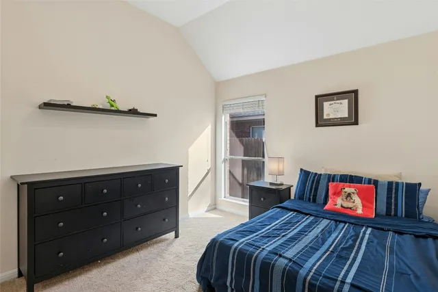 a bedroom with a bed and a dresser