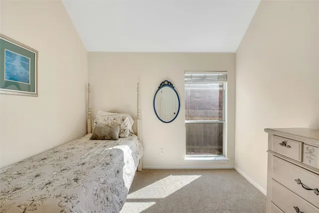 a bed room with a bed and a painting on the wall