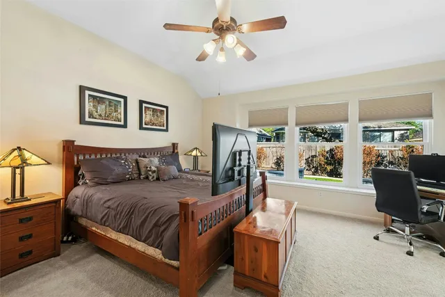 a bedroom with a large bed and a chandelier