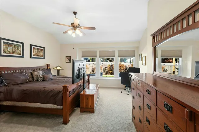 a living room with furniture a chandelier and a flat screen tv