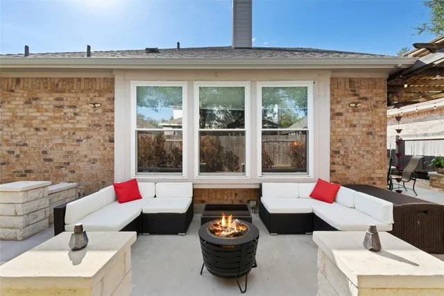 a living room filled with furniture and a floor to ceiling window