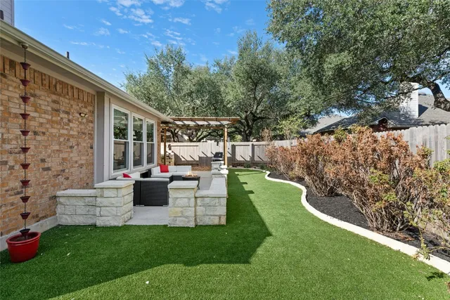 a view of a house with backyard sitting area and garden