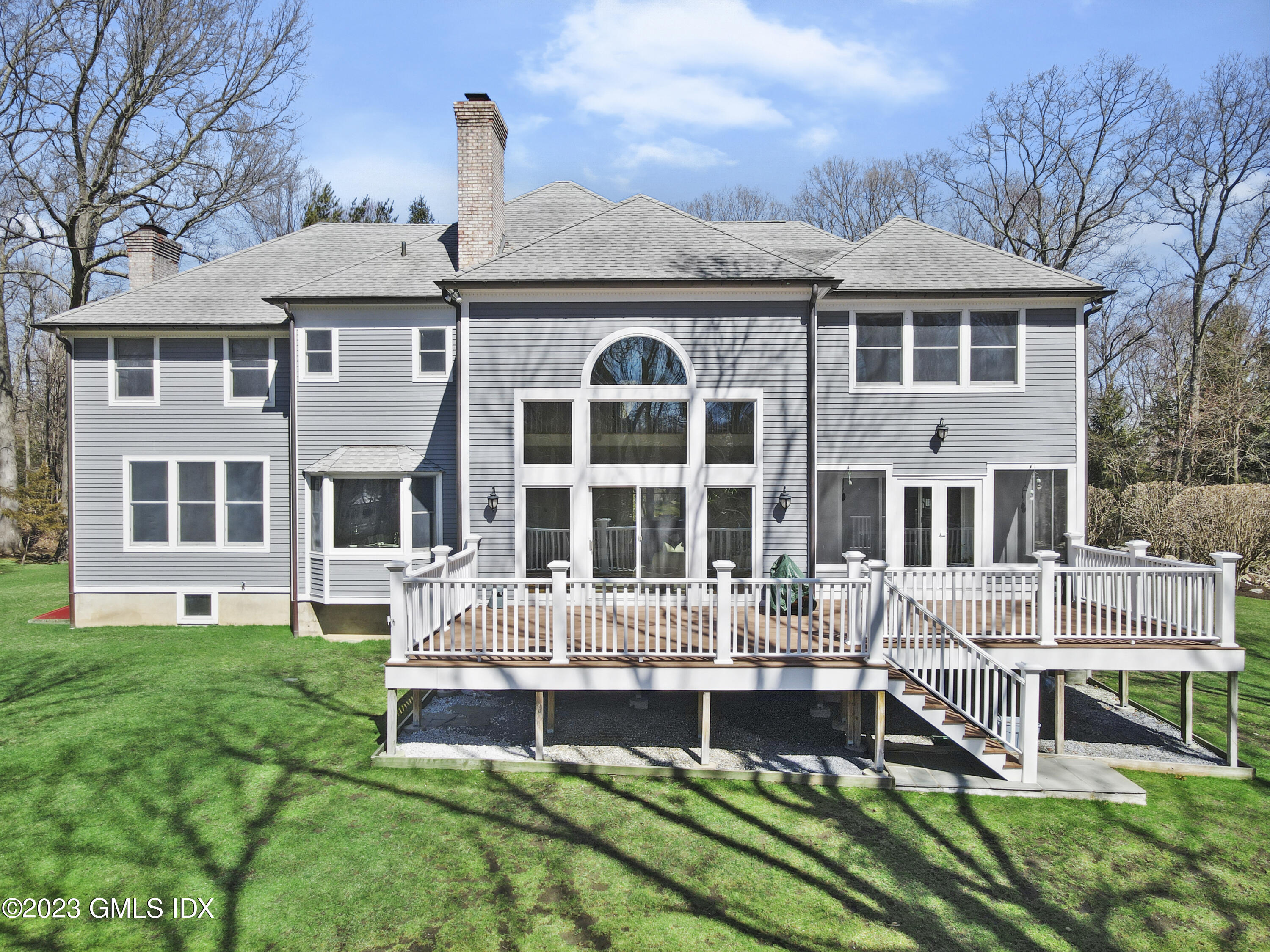 12 Juniper Hill Road Greenwich, CT 06830 - Photo 50 of 61 a front view of a house with a yard table and chairs
