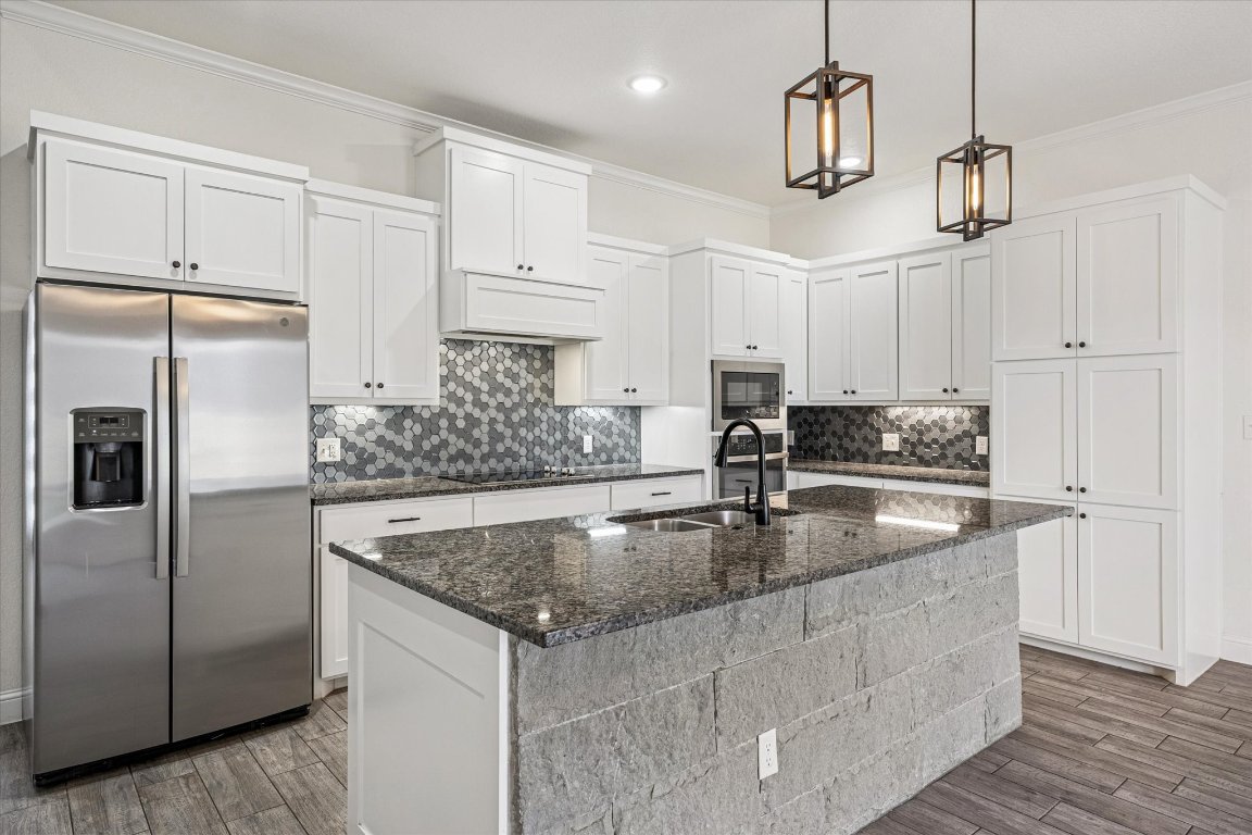 136 Greg Lane Jarrell, TX 76537 - Photo 3 of 10 a kitchen with kitchen island a counter top space appliances and cabinets