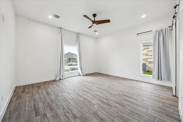 a bathroom with a granite countertop sink a toilet and mirror