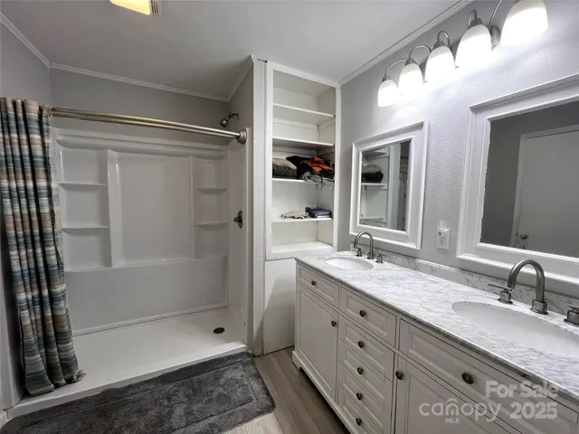 a bathroom with a granite countertop sink mirror and shower